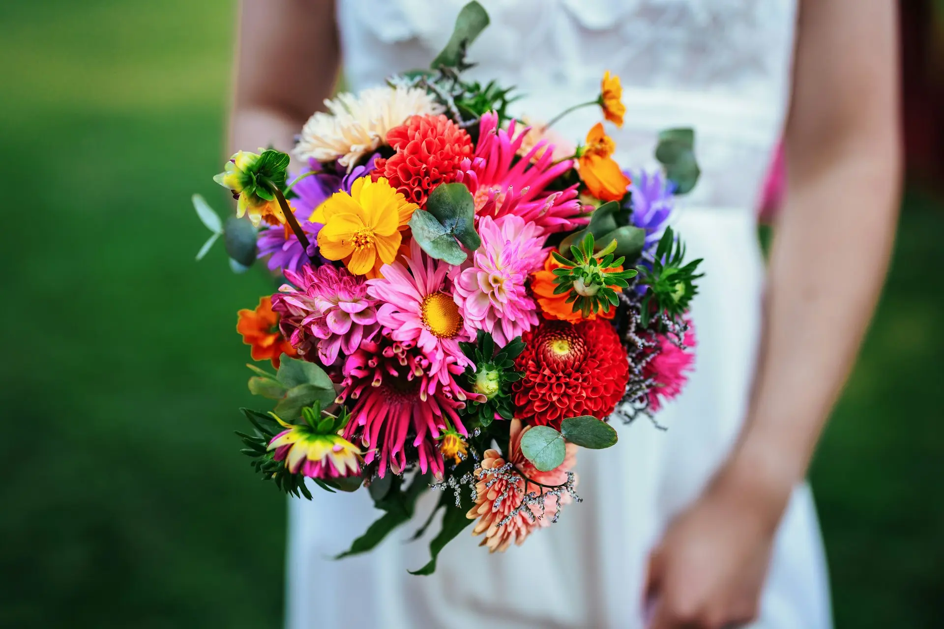 A woman in a white dress holding a bouquet of flowers